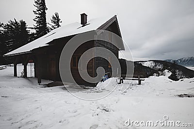 Wooden house in winter forest on a mountain Stock Photo