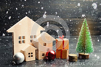 Wooden houses and Christmas tree. Christmas Sale of Real Estate. New Year discounts for buying house. Purchase apartments at a low Stock Photo