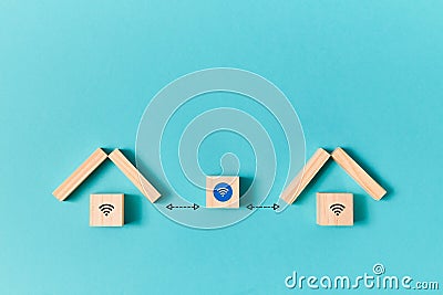 Wooden houses and cubes inside, wifi signs connected to block with wireless symbol. Networking. Online communications Stock Photo