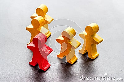A wooden human red figure stands out from the crowd. Leadership, team building, business succes concept Stock Photo