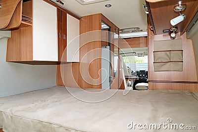 Wooden interior large bedroom of Camper van ready for vanlife holidays Stock Photo