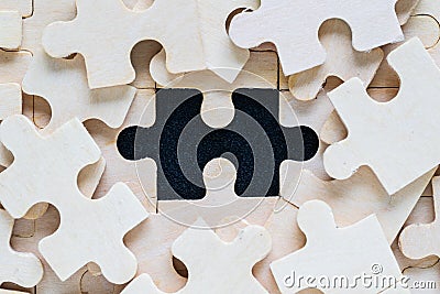 Wooden jigsaw puzzle pieces on black background Stock Photo