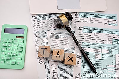 wooden judge gavel on 1040 individual income tax form Editorial Stock Photo