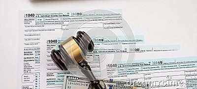 wooden judge gavel on 1040 individual income tax form Editorial Stock Photo