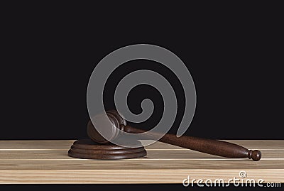 Wooden judge gavel on wooden table, black background. Wood hammer auction Stock Photo