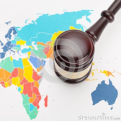 Wooden judge's gavel and over world map - close up shot Stock Photo