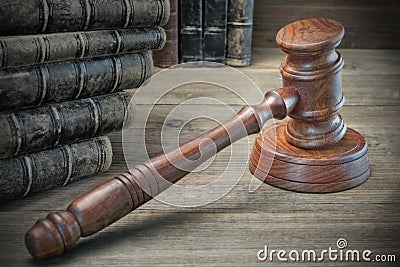 Wooden Judges Gavel And Old Law Books On Wooden Background Stock Photo