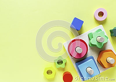 Wooden kids toys on colourful paper. Educational toys blocks. Toys for kindergarten, preschool or daycare. Stock Photo