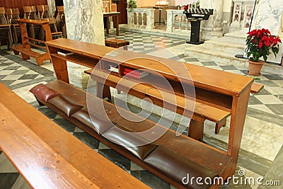 Kneel for faithful pray in the church Stock Photo