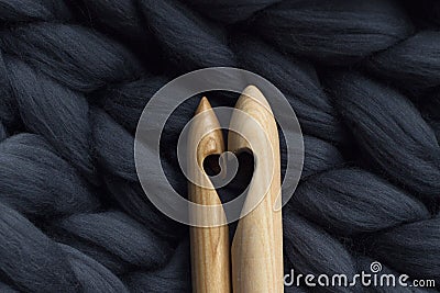 Wooden knitting needles on background of grey merino wool blanke Stock Photo