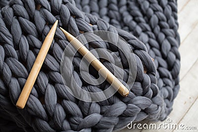 Wooden knitting needles on background of grey merino wool Stock Photo