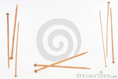 Wooden knitting needles frame with copy space for text on white background Stock Photo