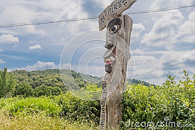 Wooden Korean totem Jangseung in rural countryside Editorial Stock Photo