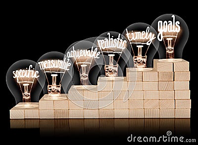 Wooden Ladder and Bulbs with Smart Goals Concept Stock Photo