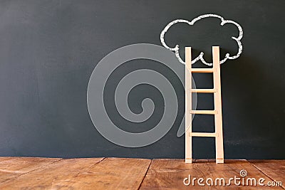 Wooden ladder and cloud infographics on blackboard background Stock Photo