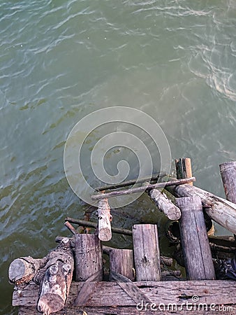 Wooden ladder from the pier into the river . Stock Photo