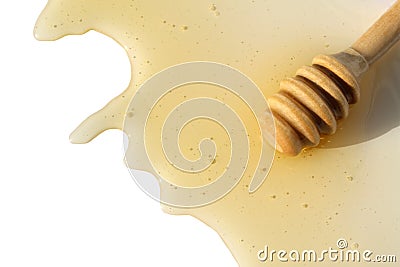 A wooden ladle with honey lies on a white isolated background. Stock Photo