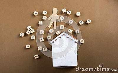 Wooden letter cubes and man figurine and house Stock Photo