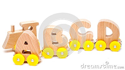 Wooden Letters A, B, C, D of a train alphabet and locomotive with yellow wheels on white background. Early childhood education, le Stock Photo