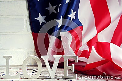 Wooden letters are laid out in the word love, July 4, happy independence day, patriotism, memory of veterans, the concept Stock Photo