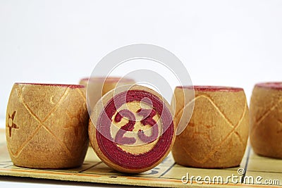 Wooden lotto barrels with numbers. Isolated on a white background. Family bingo game. Stock Photo