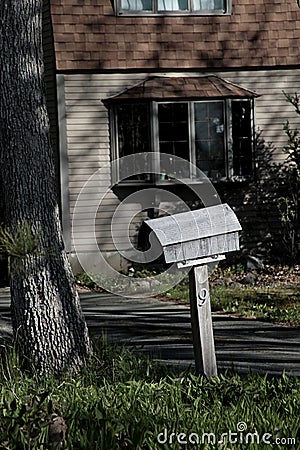 Wooden mailbox assorted to the wooden house in Manchester area, US Stock Photo