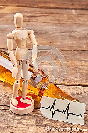 Wooden man figure, heart impulses. Stock Photo