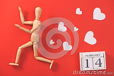 Wooden man figure running to escape from love. Stock Photo