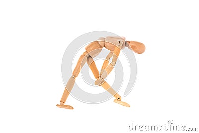 wooden man holds his leg with his hands isolated on white background. Stretch concept Stock Photo