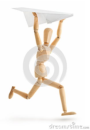 Wooden man running with paper airplane Stock Photo