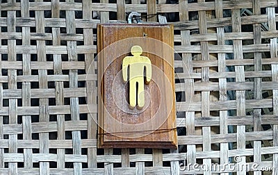 A wooden man sign on the wall in classic woven wood stlye Stock Photo