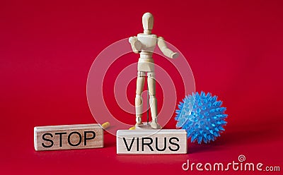 A wooden man stands on the jeng with the words stop virus Stock Photo