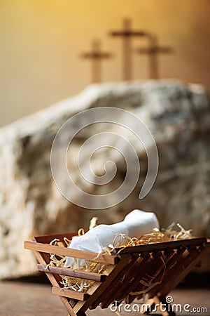 Wooden manger, three crosses background. Jesus - reason for season. Christian Christmas, Easter concept. Born to Die Stock Photo