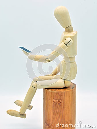 Wooden mannequin with a mobile in hand Stock Photo