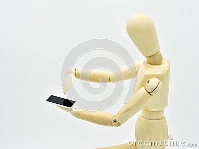 Wooden mannequin with a mobile in hand Stock Photo