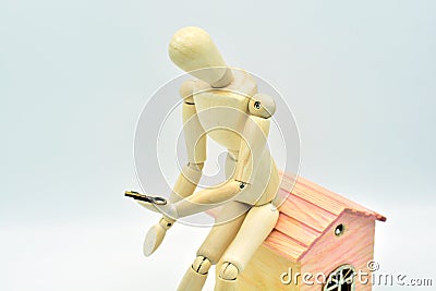 Wooden mannequin sitting in a house Stock Photo