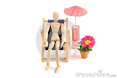 Wooden mannequin taking sunbath in deck chair Stock Photo