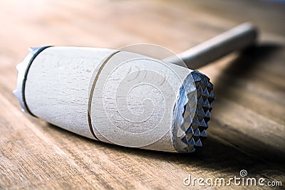 A Wooden Meat Mallet Lying Down On A Table Stock Photo