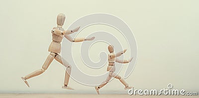 Wooden men mannequins run after each other or run away Stock Photo