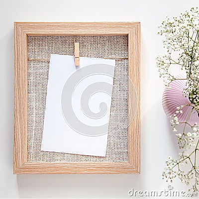 A wooden mockup frame with a white card and a pink vase Stock Photo