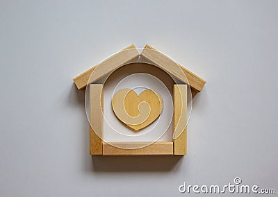 Wooden model of house from blocks. Heart sign. Place for your text. White background. Business concept Stock Photo