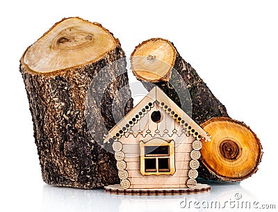 Wooden model of house and stack of wood Stock Photo