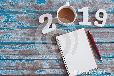 Wooden number and hot coffee with 2019 text and notebook Stock Photo