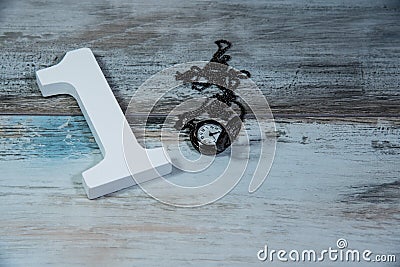 Wooden number one and clock measuring time Stock Photo