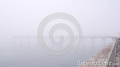 Wooden Ocean Beach pier in fog, misty calm boardwalk in haze, California coast. Stock Photo