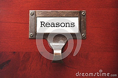 Wooden Office File Cabinet with Reasons Label Stock Photo