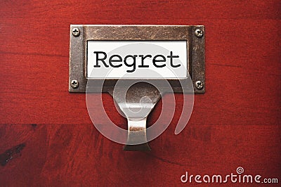 Wooden Office File Cabinet with Regret Label Stock Photo