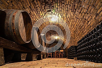 Wooden old barrels in the rustic wine cellar with brick walls in hajos hungary Stock Photo