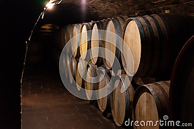 Wooden old barrels in the rustic wine cellar with brick walls in villany hungary Stock Photo