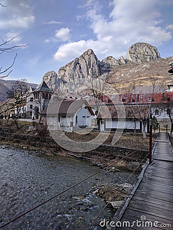 Wooden old bridge over river to the mountain monastery Stock Photo